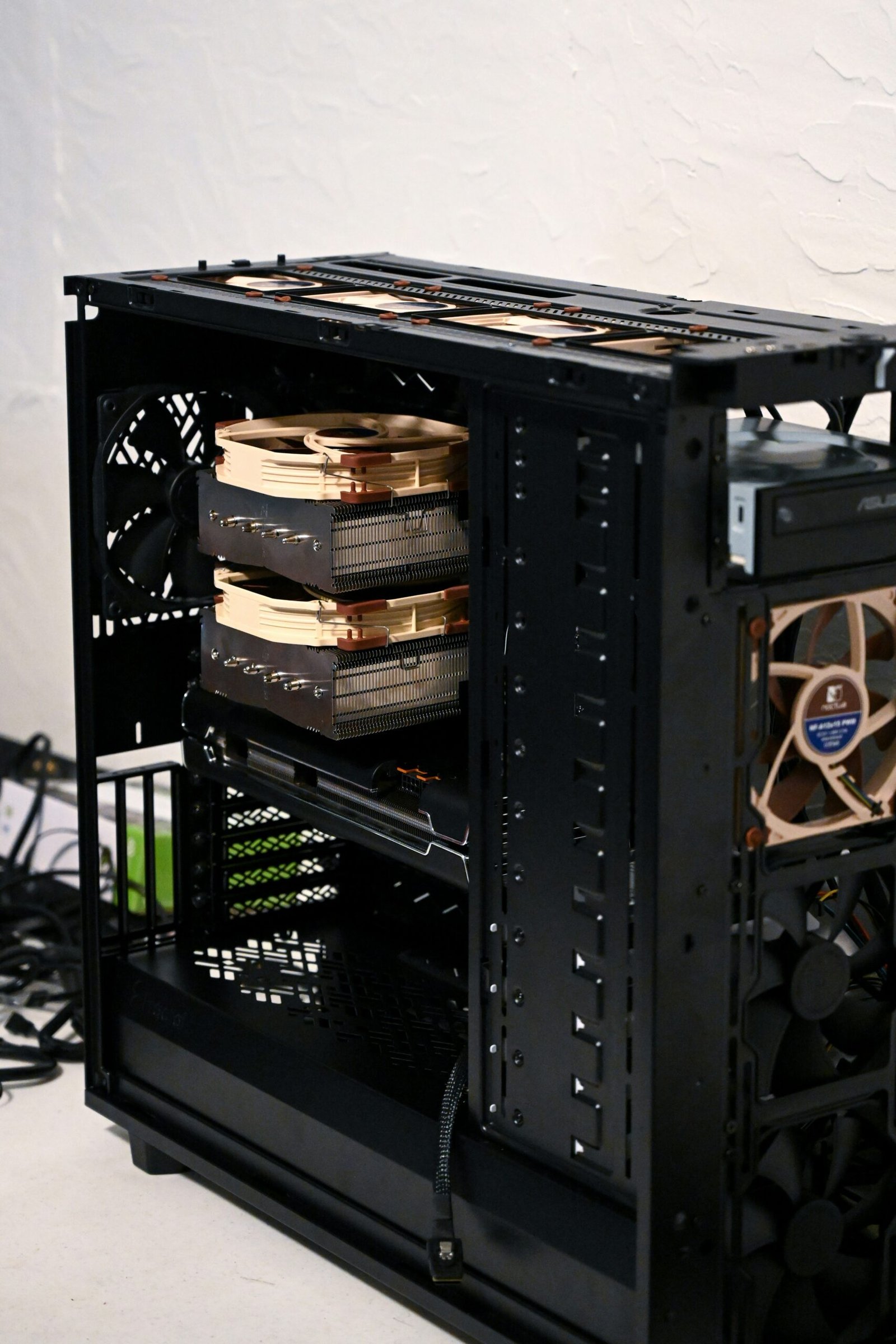 Inside view of a black PC tower with the cover off, showing internal components of the computer.